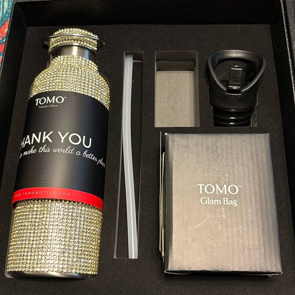 Tomo brand gold water bottle with sport cap and glam bag
